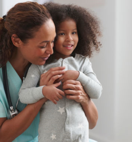 Nurse hugging a child